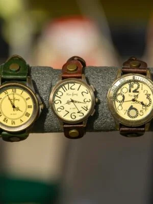 Assorted vintage watches with leather straps on a display rack.